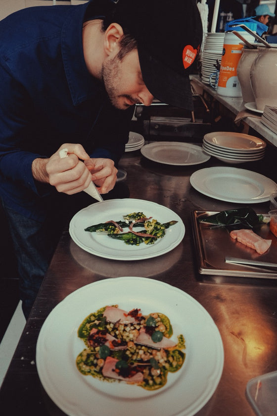 Finishing a dish in the Vinoria Lilo kitchen